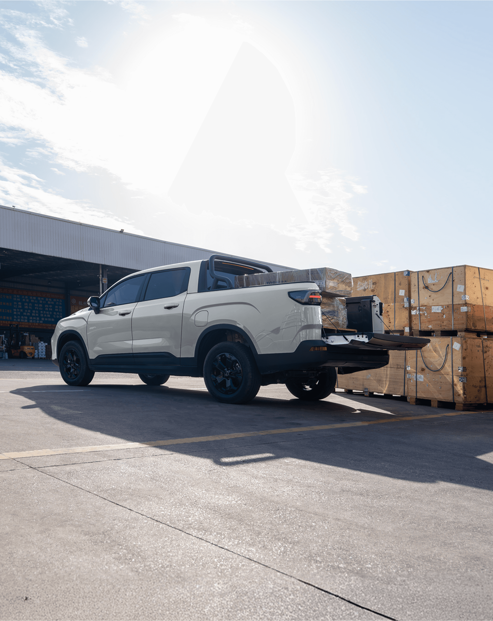 Geely Riddara with tailgate down and cargo loaded at a warehouse